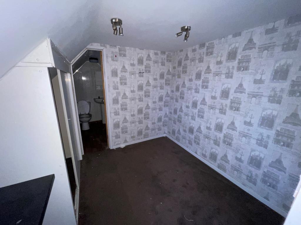 Lot: 57 - FLAT FOR REFURBISHMENT/COMPLETION - Room leading to shower room with W.C.